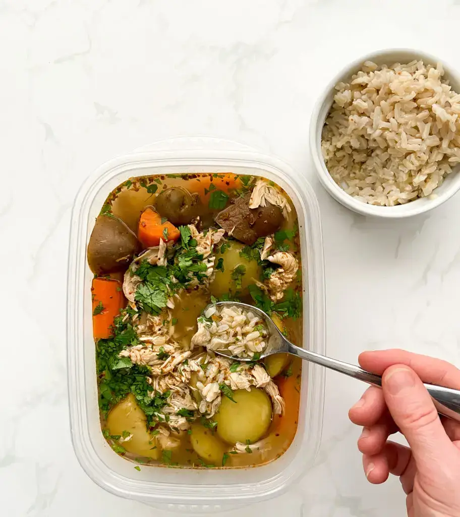 A steaming bowl of Caldo De Pollo Mexican Chicken Soup with lime and cilantro — Sugar Face Bakes