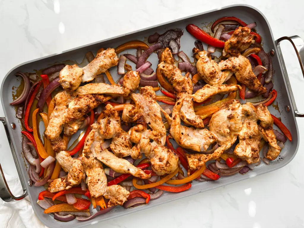 Chicken fajitas on sheet pan before baking