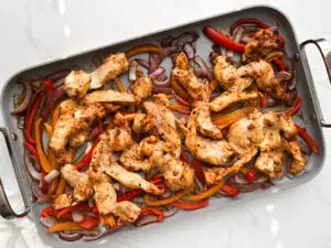 Chicken fajitas on sheet pan before baking