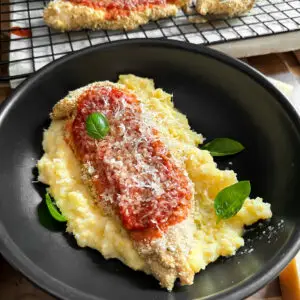 baked chicken parmesan- Baked Chicken Parmesan Chicken Parmesan recipe with homemade marinara sauce, fresh parmesan cheese over a bed of creamy polenta.