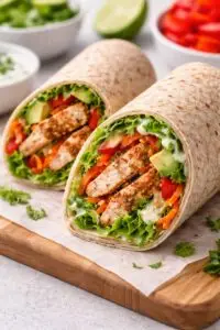 chicken marbella- Chicken Marbella Assembling healthy chicken wrap with vegetables and sauce