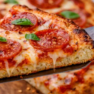 cottage cheese pizza- High Protein Cottage Cheese Pizza Close-up of crispy cottage cheese pizza crust with melted mozzarella, pepperoni, and golden edges showing airy high-protein texture