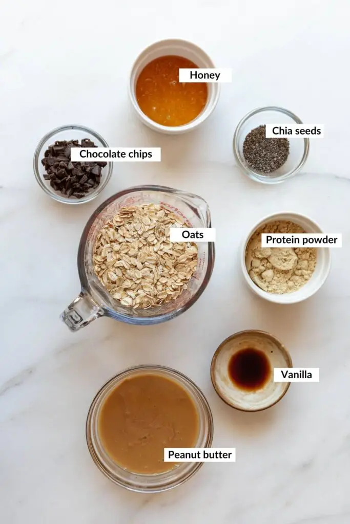 Ingredients for no bake protein balls including oats, protein powder, peanut butter, honey, and milk in a bowl for a healthy no-bake snack
