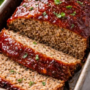 meatloaf- Easy and Juicy Meatloaf Juicy homemade meatloaf sliced in loaf pan with glossy ketchup brown sugar glaze and tender interior