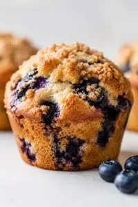 Bakery-style blueberry muffins with brown sugar streusel topping, baked until golden brown and bursting with juicy blueberries.