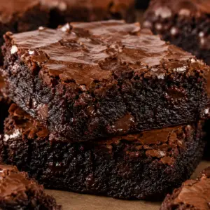 chocolate brownies with cocoa powder- Chocolate Brownies with Cocoa Powder Stack of thick homemade chocolate brownies made with cocoa powder featuring glossy crackly tops, fudgy centers, and melted chocolate chips in a close-up macro food photograph.