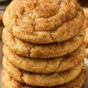 snickerdoodle cookies- Soft & Chewy Snickerdoodle Cookies A close-up stack of soft and chewy homemade snickerdoodle cookies coated in cinnamon sugar with crackly tops and golden edges on a white ceramic plate.
