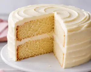 Moist vanilla cake recipe with fluffy vanilla sponge layers and homemade vanilla buttercream frosting on a classic two-layer birthday cake.