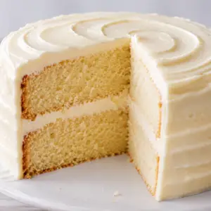 Moist vanilla cake recipe with fluffy vanilla sponge layers and homemade vanilla buttercream frosting on a classic two-layer birthday cake.
