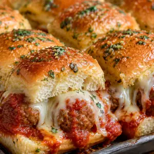 crockpot italian meatball sliders- Crockpot Italian Meatball Sliders Close-up of cheesy Crockpot Italian Meatball Sliders made with Hawaiian rolls, marinara sauce, mozzarella cheese, and garlic butter topping.