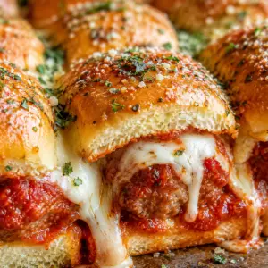 meatball sliders- Meatball Sliders Close-up of baked meatball sliders made with Hawaiian rolls, marinara sauce, melted mozzarella cheese, and garlic butter topping.